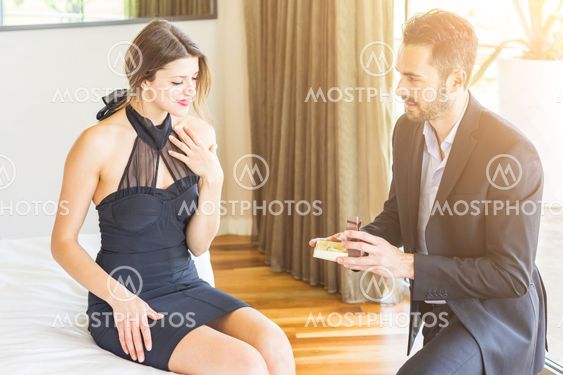 Love couple with man asking her girlfriend to get married