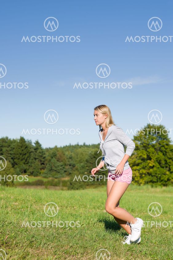 Jogging young sportive woman meadows sunny day