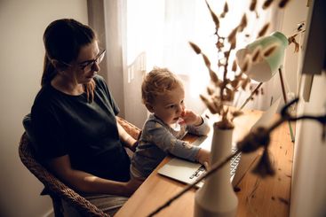 Woman working at home with her baby
