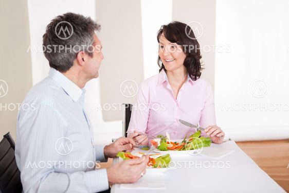 Mature couple having lunch at home