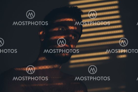 Young man sad and depressed sitting alone