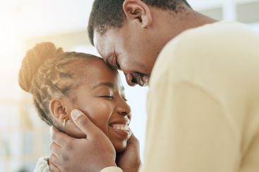 Forehead, smile or black couple hug in home living room...