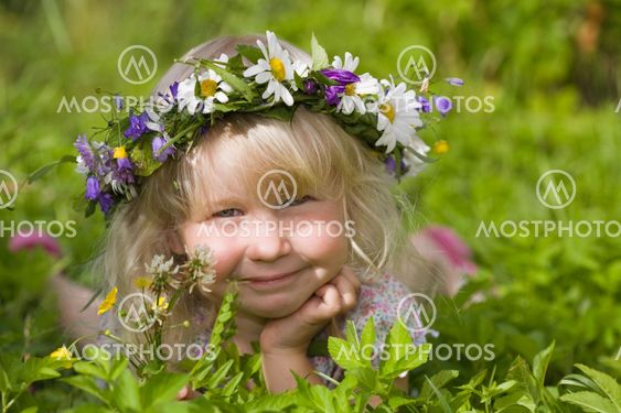 happy little girl on green meadow