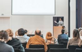 Speaker giving a talk in conference hall at business...