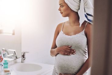 Pregnancy, motherhood and african woman in home for...