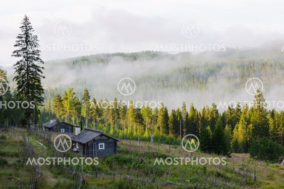 Mist over hills and buildings at Ransby, Värmland, Sweden,