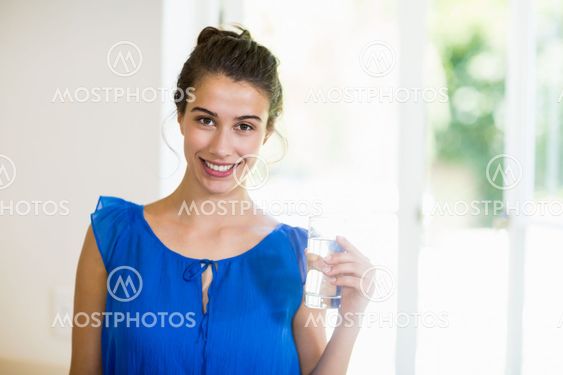 Young woman holding glass of a water