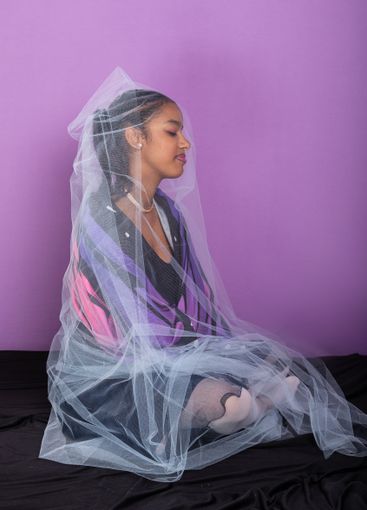 Teenage brunette girl sitting dressed in butterfly wings...