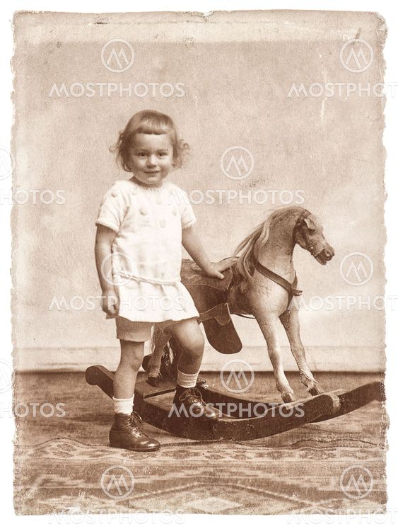 old photo of little girl with rocking horse toy.nostalgic...