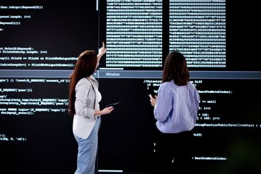Female Programmer Analyzing Code on Laptop