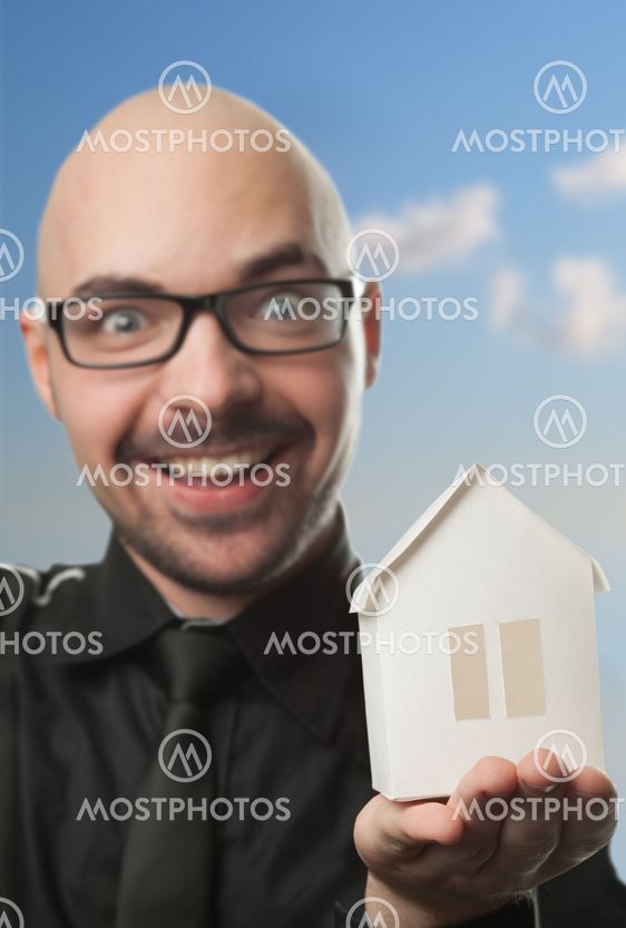 Man holding a paper house.