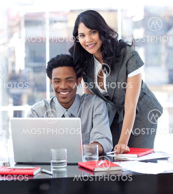 Businesswoman and businessman working with a laptop