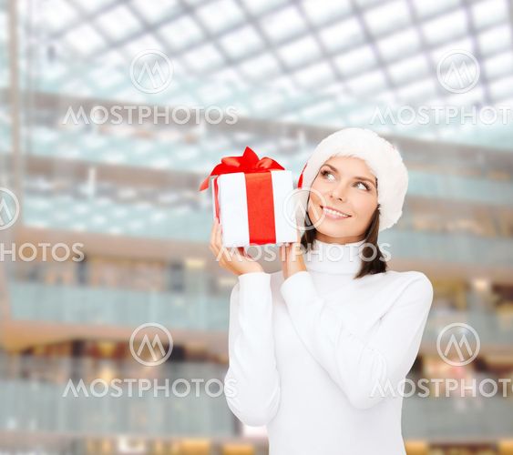 smiling woman in santa helper hat with gift box