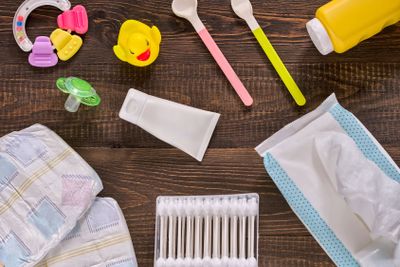Baby essentials and care on dark wooden table