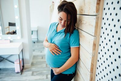 close up portrait of a pregnant stomach sitting