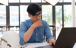 Architect and engineer working on a laptop with...