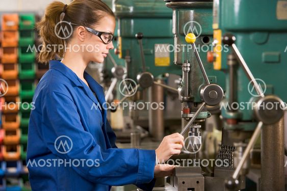 Machinist working on machine