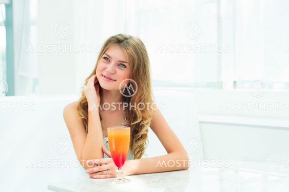 Portrait of a cute woman in a city cafe