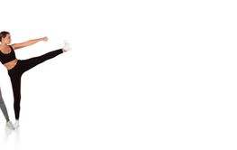 Two women performing dynamic dance poses in a bright...