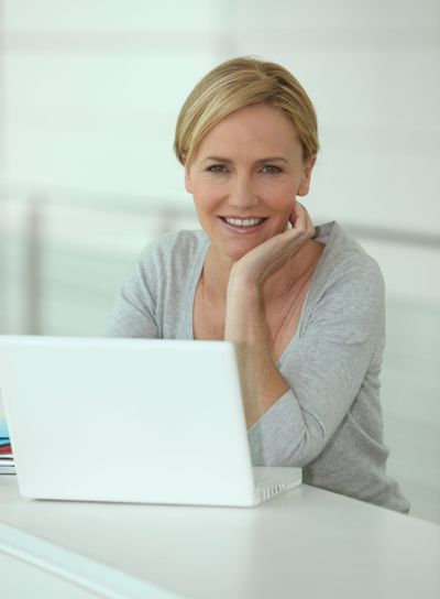 Blond woman in front of laptop computer