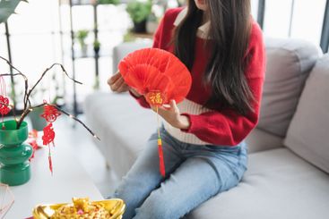 Asian Woman decorated house for Chinese New Year...