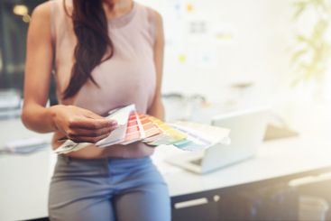 Woman, color swatch and hands in office for business,...