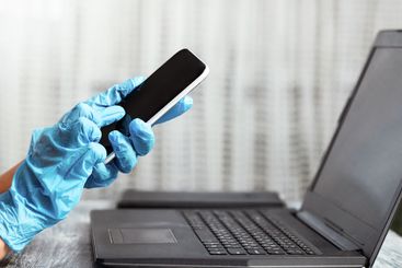 Woman in quarantine wearing protective gloves and...