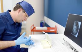 Oncologist performing a cancer biopsy test during the...