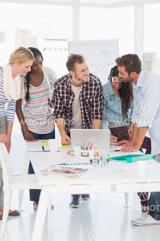 Happy team of young designers having a meeting