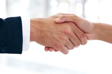 Closeup, business people and handshake in office,...