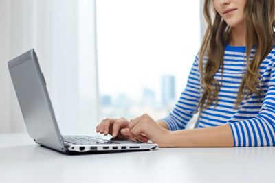 student girl typing on laptop computer