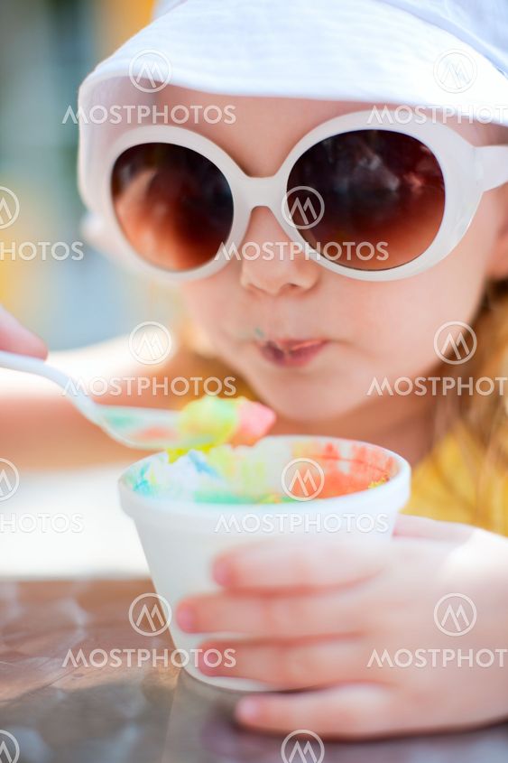 Adorable girl eating ice cream