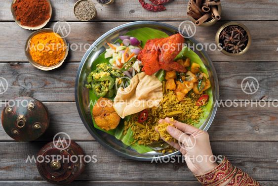 Indian people eating biryani rice