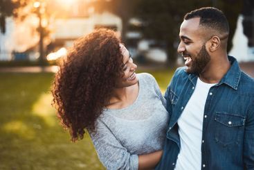Love, couple and laughing outdoor together for sunset...