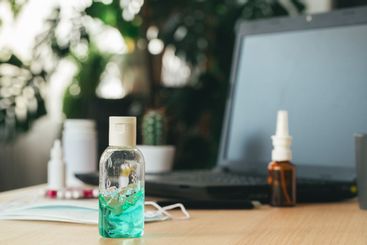 Working place table with small bottle of antibacterial...