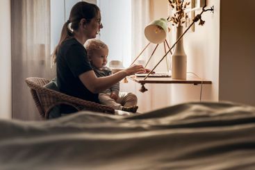 Woman working at home with her baby