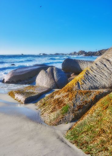 Rocks, sand and beach shore for peace, holiday trip and...