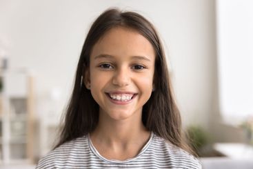 Headshot portrait smiling little preteen age girl look...