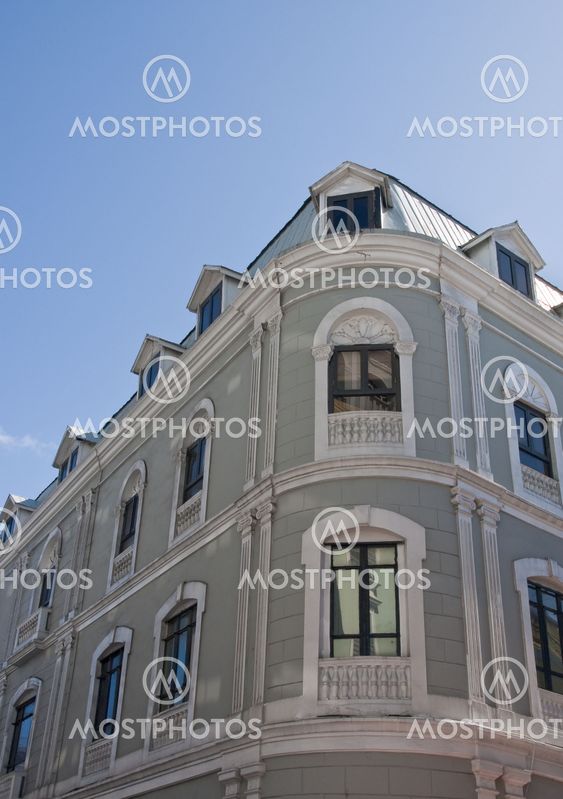 Gray Curved Building Under Blue Sky