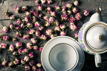 Vintage teapot and cup with blooming tea flowers on...
