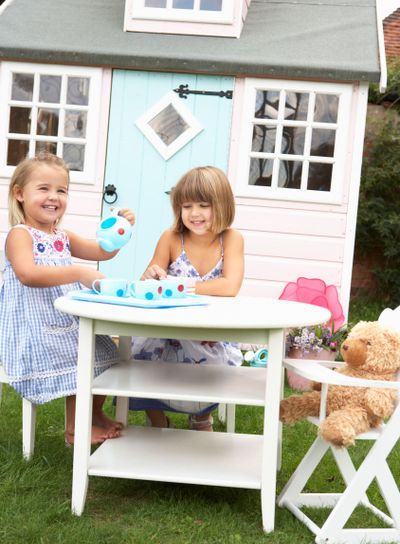 Two young girls play outdoors