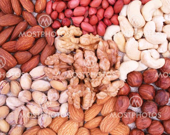 Assorted filbert, peanut, pistachios, walnut, almonds and hazelnuts on natural sackcloth can use as background