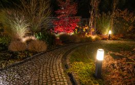 Beautiful Garden Path Illuminated at Night With Colorful...