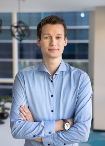 Positive young Caucasian business leader man posing in...