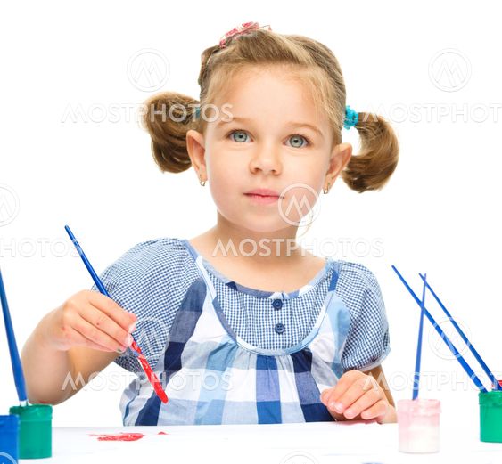 Little girl is painting with gouache