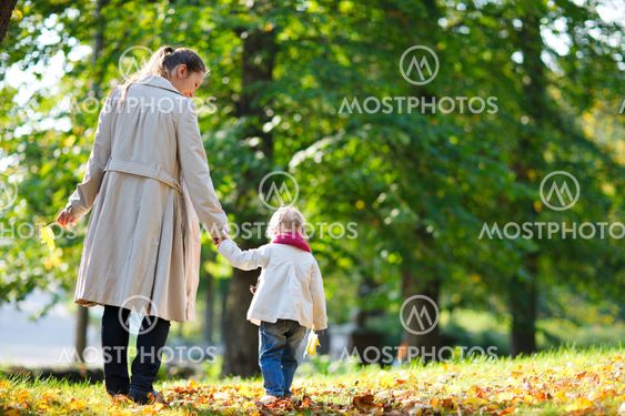Mother and daughter walking in park