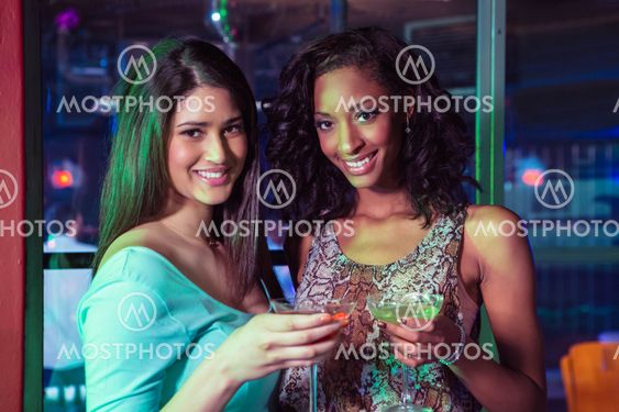 Portrait of two women having cocktail
