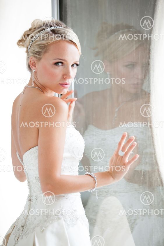 Beautiful blond bride reflection in window