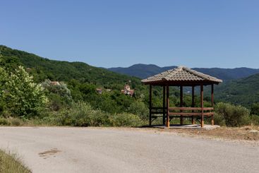 Wooden gazebo in the mountains near the mountain road...