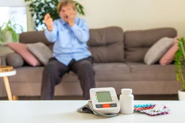 An old woman measures her blood pressure. Selective focus.